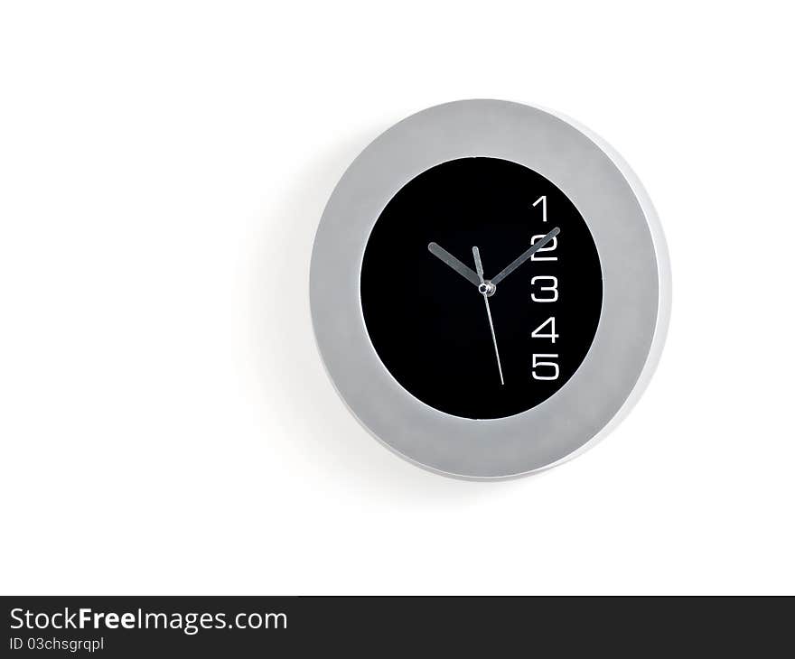 Grey and black wall clock on white background.