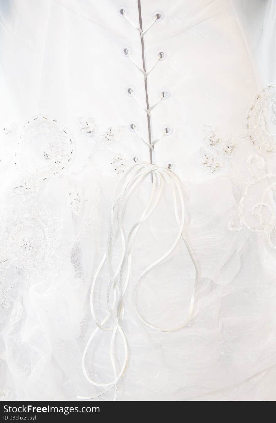 Detail shot of laces on back of wedding dress. Detail shot of laces on back of wedding dress