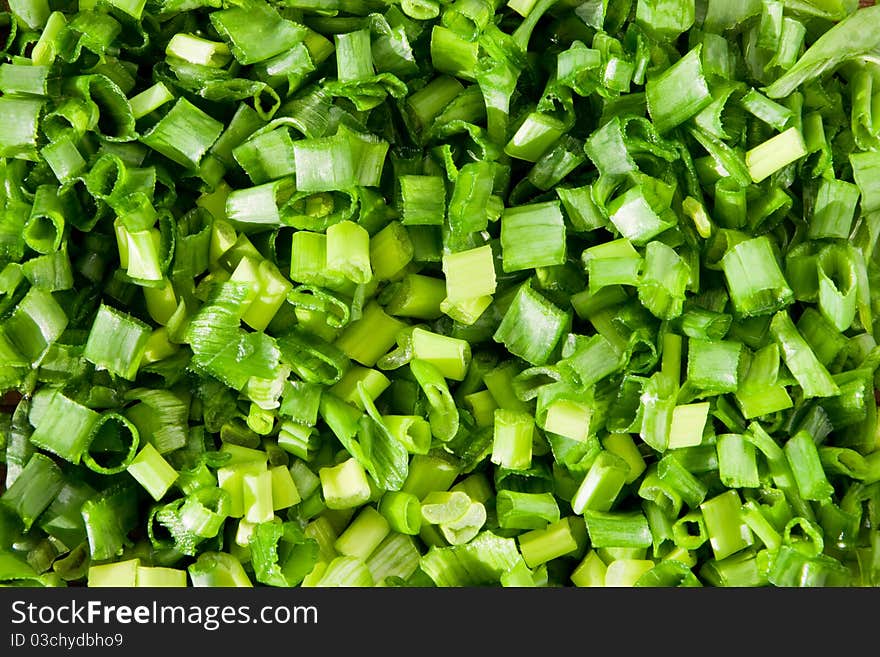 Chopped green spring onions background. Chopped green spring onions background