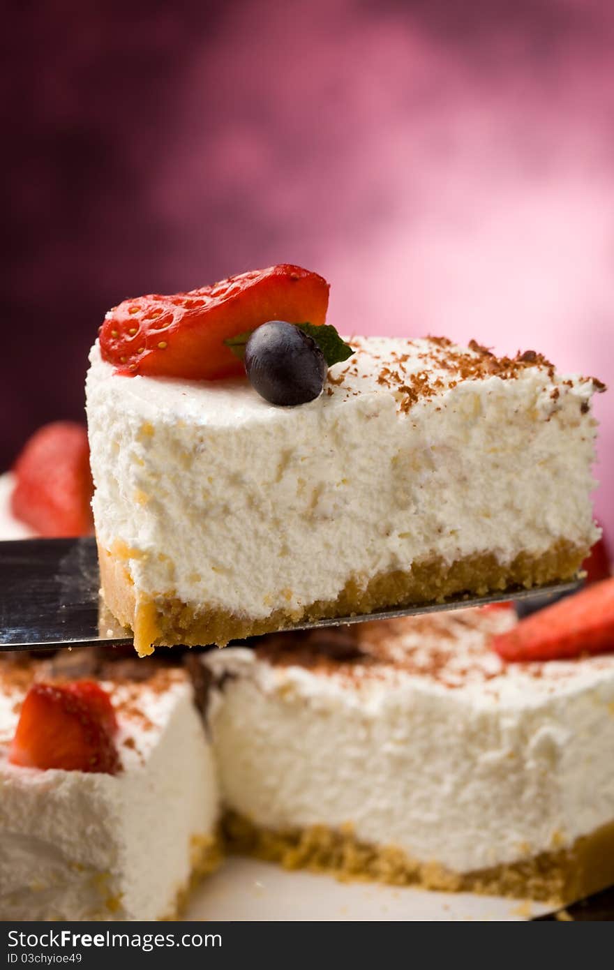 Photo of delicious cake with strawberries on wooden table