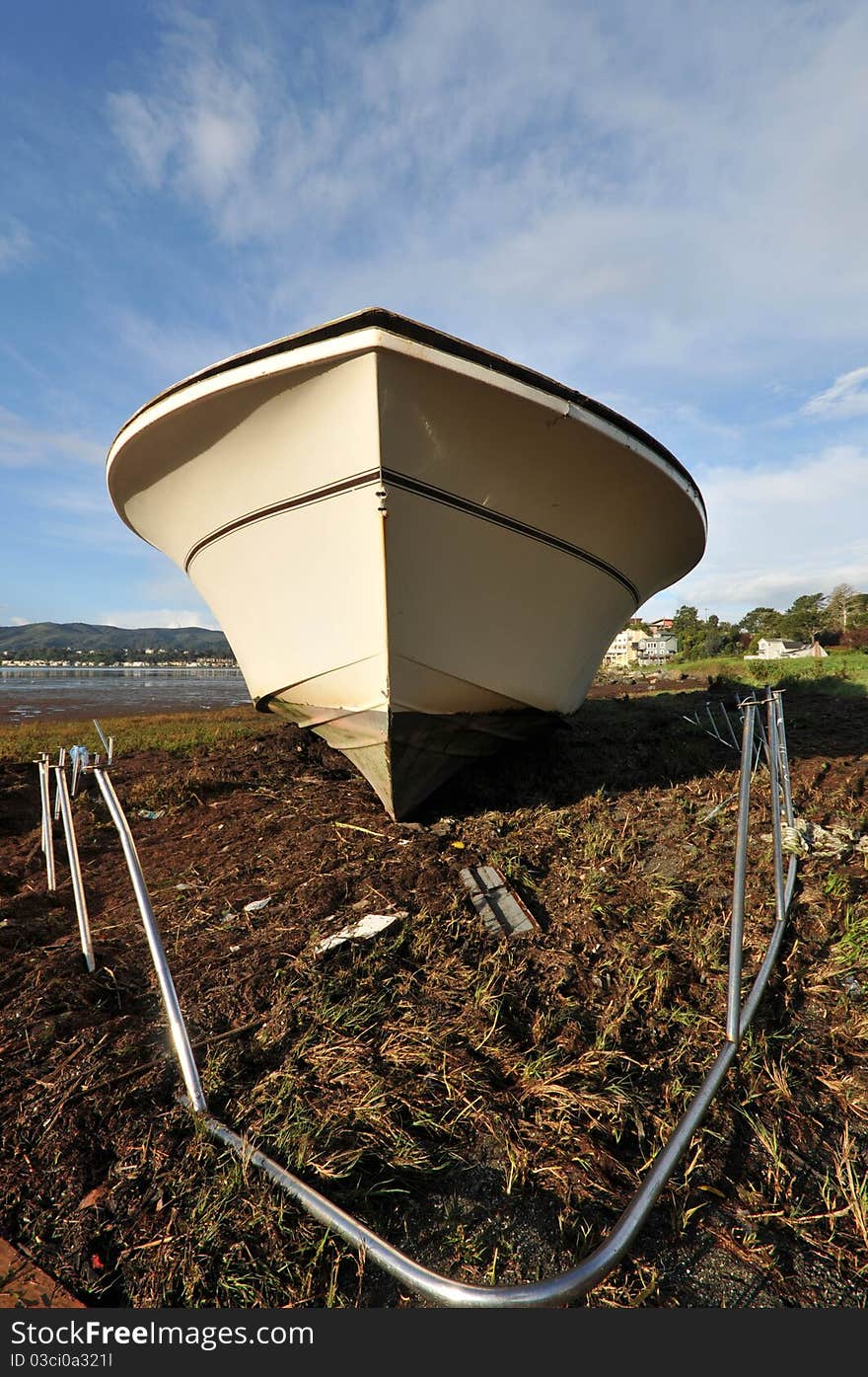 Shipwreck on shore with ground underneath boat