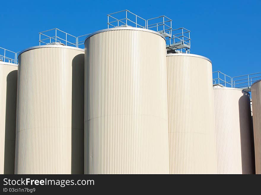 Refinery oil storage tanks and blue sky