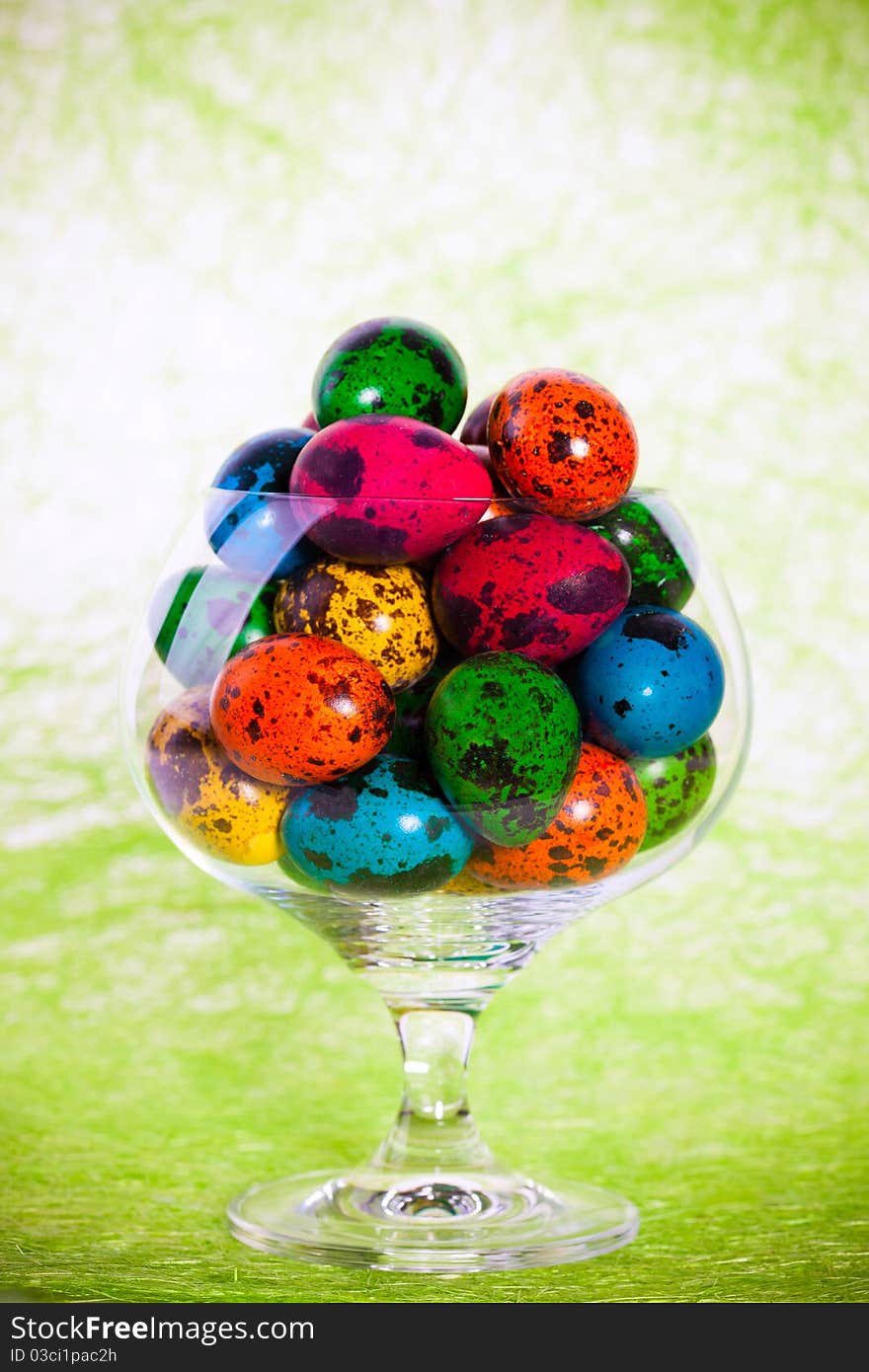 Closeup portrait of Easter colorful eggs in glass