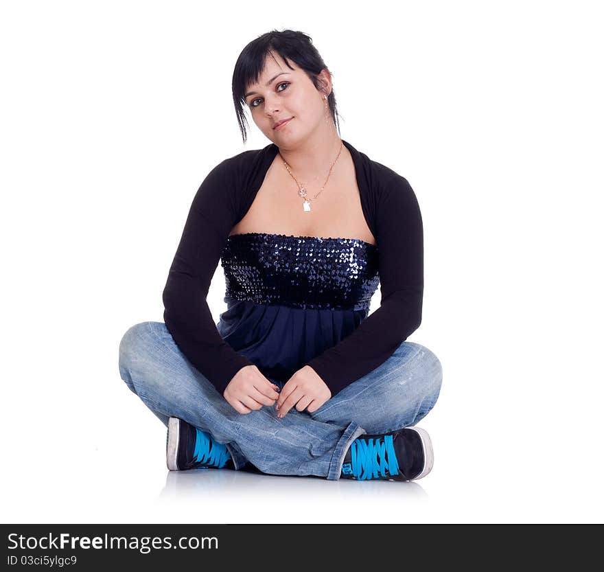 Girl in jeans sitting in the lotus position on white background