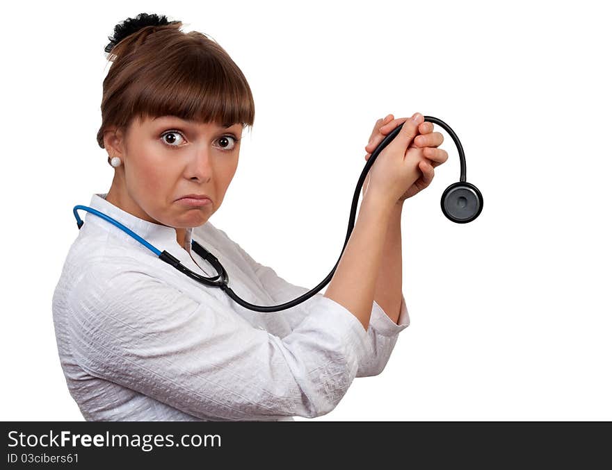 Beautiful young woman doctor with a stethoscope sings on a white background