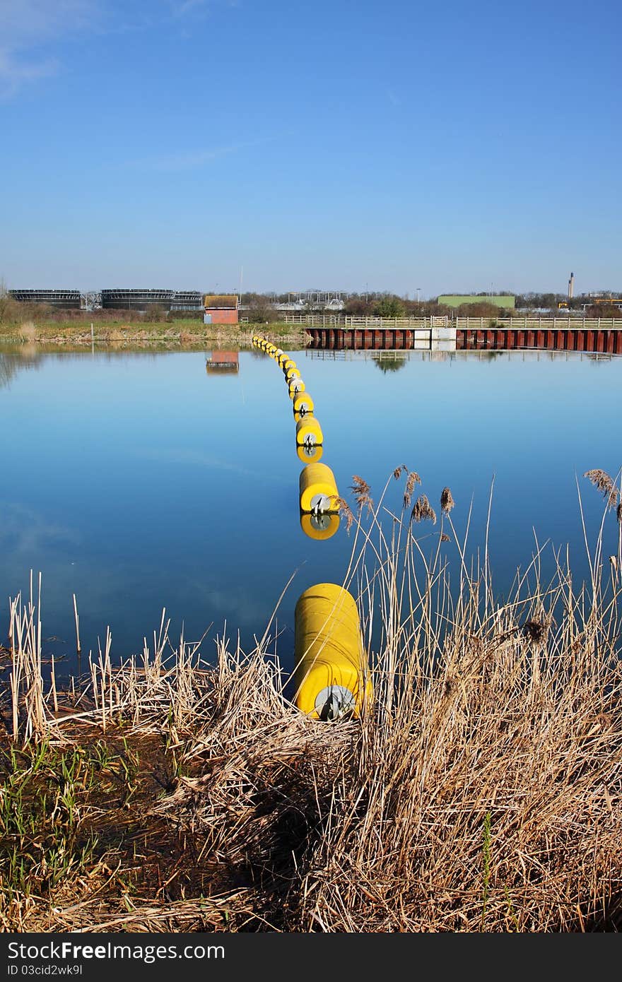 Floating Barrier on a tranquil blue River