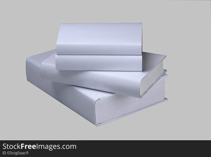 Stock of four plain, white books. Stock of four plain, white books