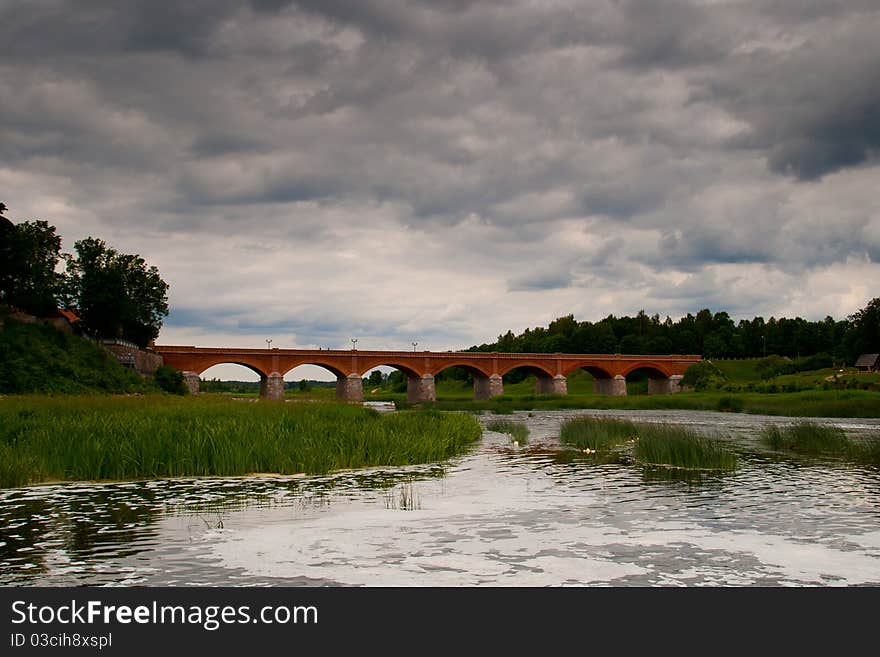 Old red brick bridge and dark skies