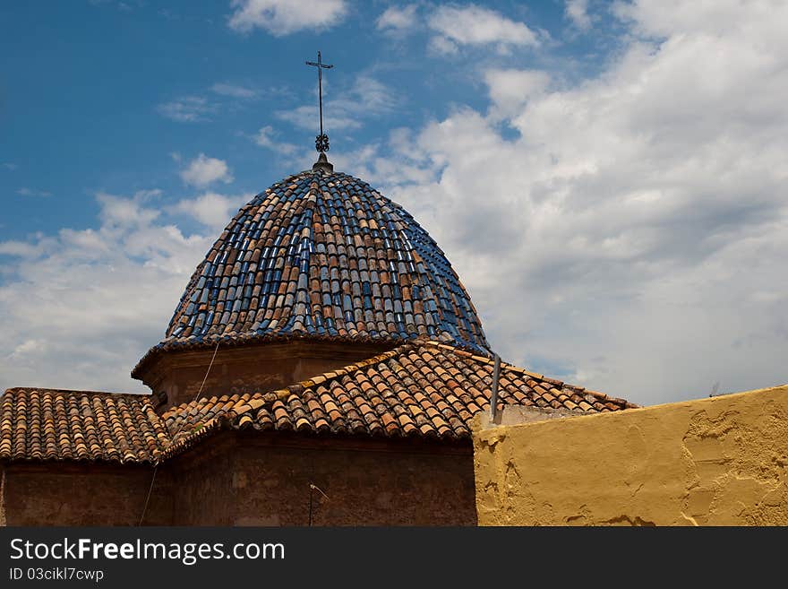 Old churches colored tile roof against blue sky