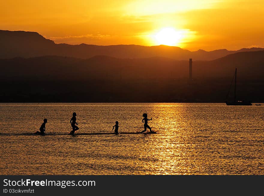 A beautiful sunset on sea with a silouettes. A beautiful sunset on sea with a silouettes.