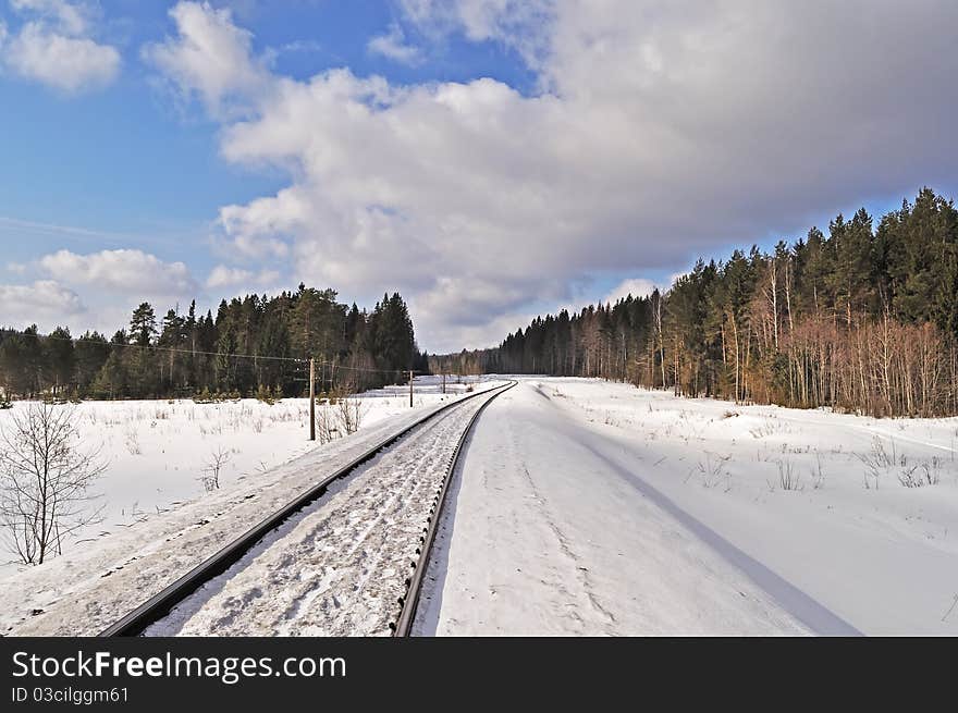 Railroad in winter forest