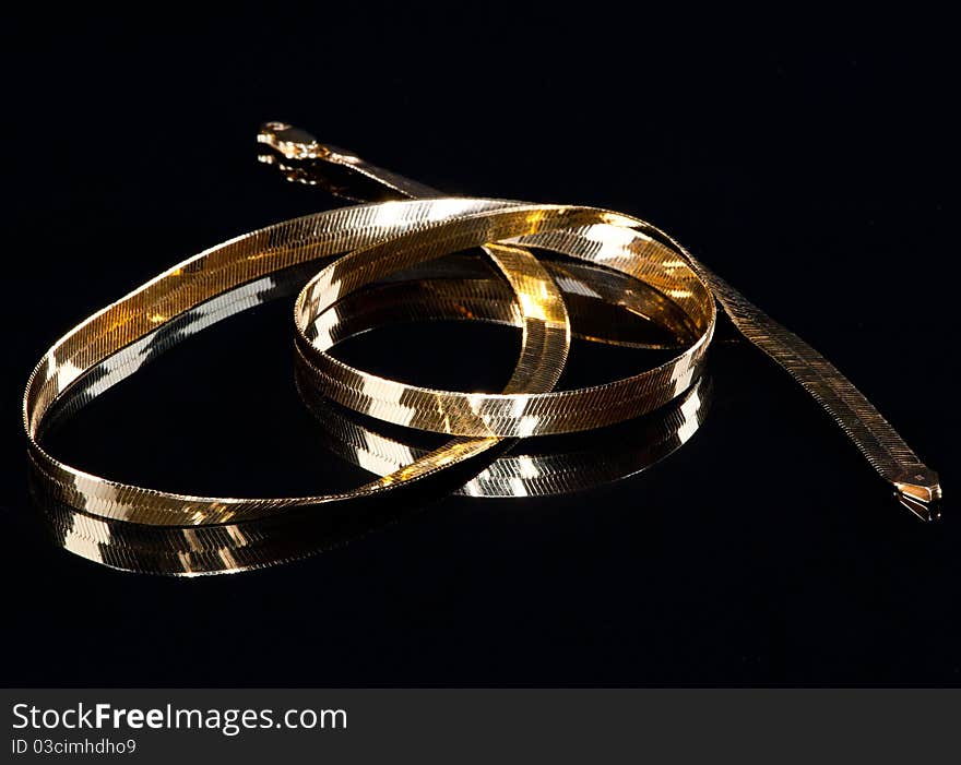 Beautiful golden necklace in a black background. Beautiful golden necklace in a black background