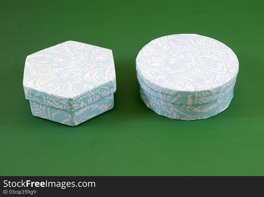 Small cardboard boxes on a green background