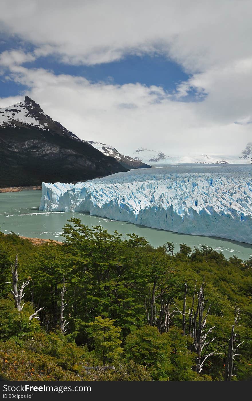 Perito Moreno Glacier, at the Patagonia, in Argentina, with mountains in the background and woods in the foreground. Perito Moreno Glacier, at the Patagonia, in Argentina, with mountains in the background and woods in the foreground