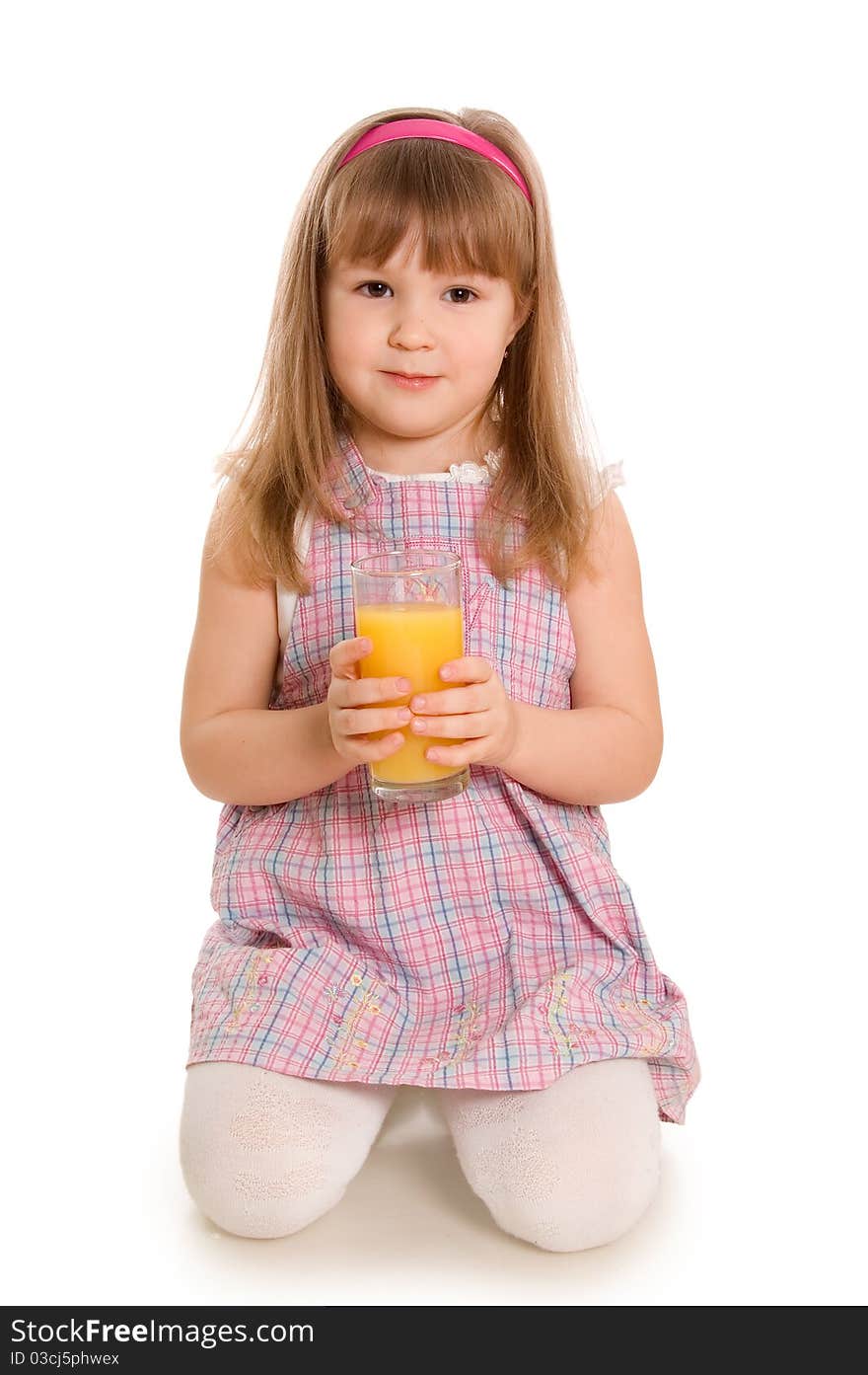 The little girl drinks orange juice