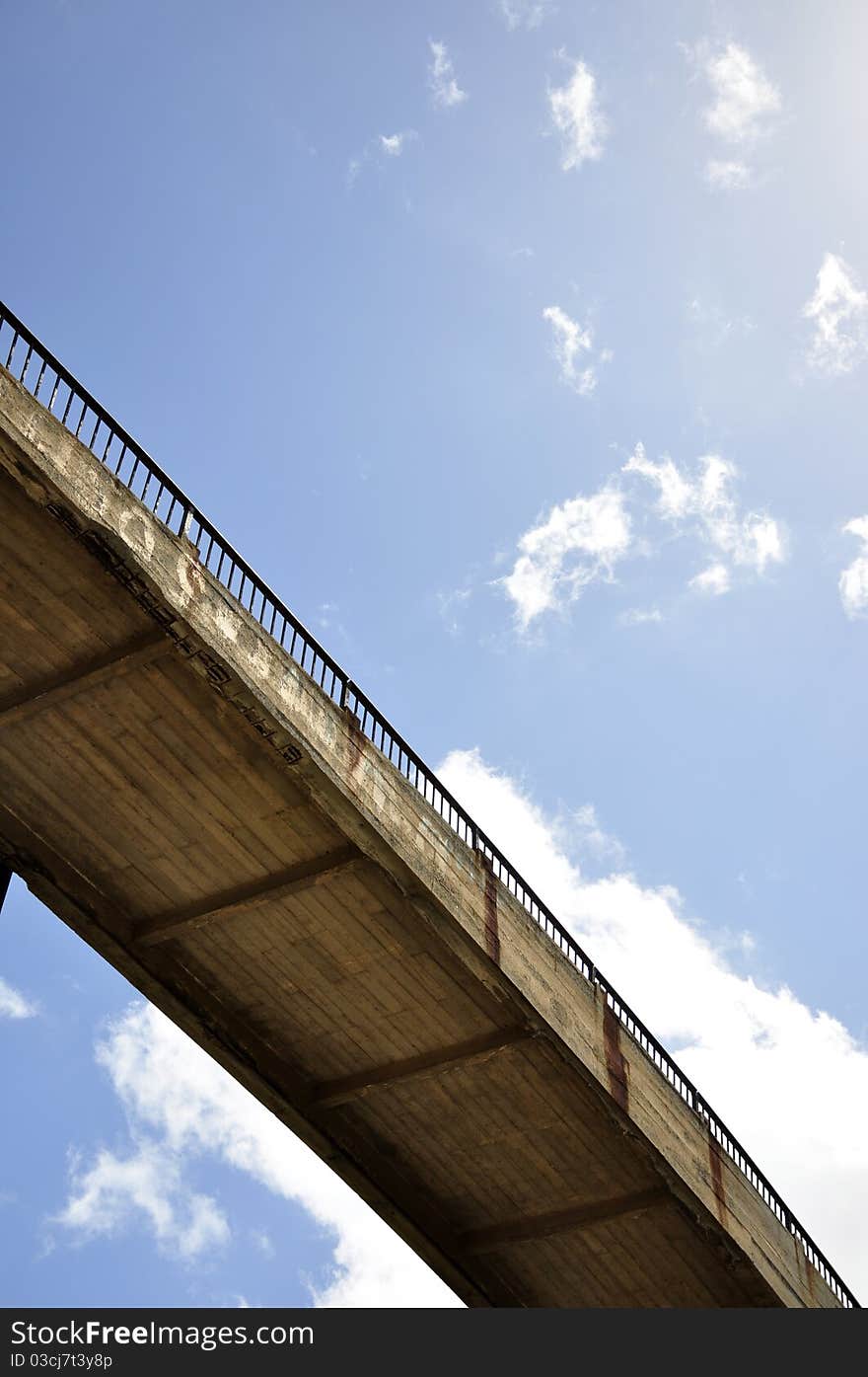 Concrete bridge under the blue sky with clouds. Concrete bridge under the blue sky with clouds