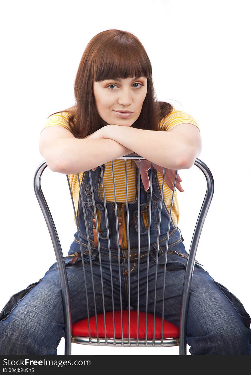 Positive adult woman sitting on a chair on a white background isolated