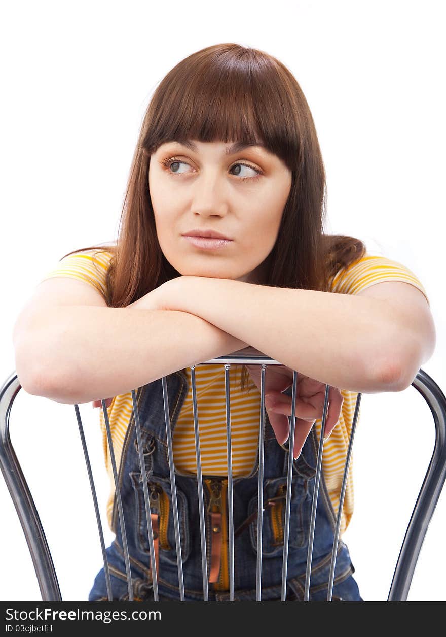 Positive adult woman sitting on a chair on a white background isolated