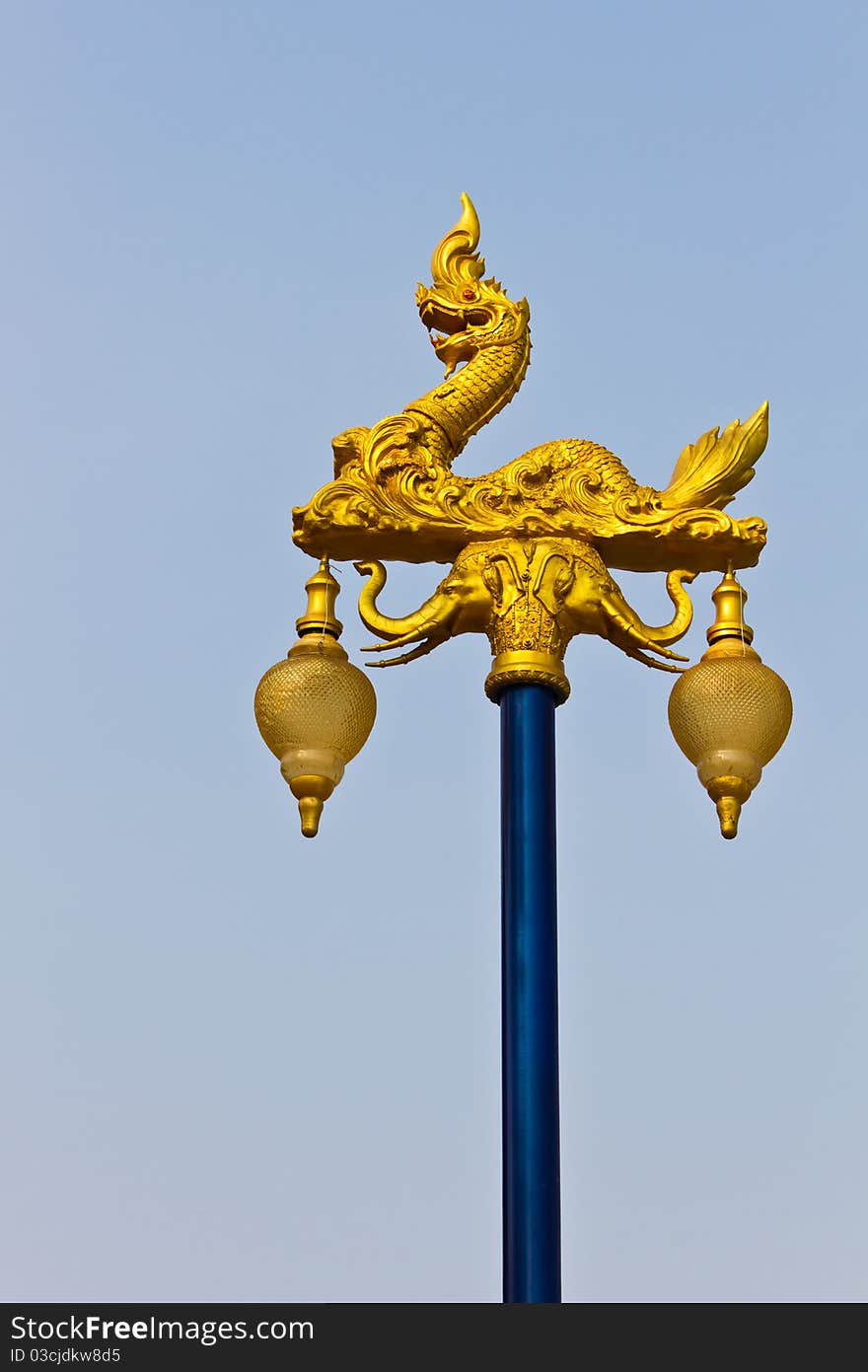 The golden naga on light pillar lantern, Thailand. The golden naga on light pillar lantern, Thailand