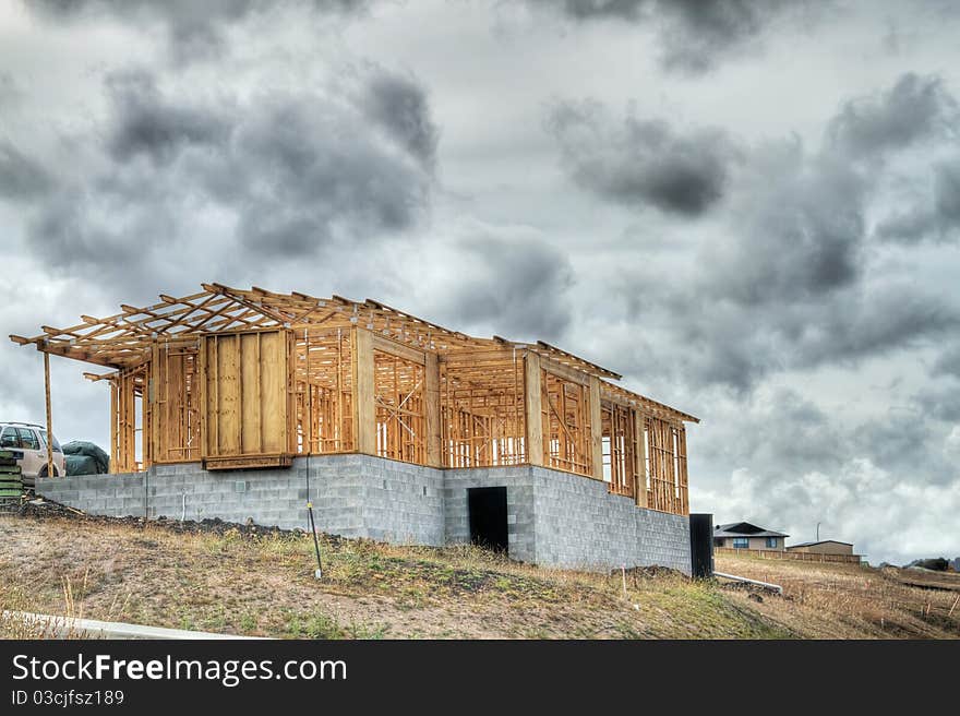 A new home being built on a hill top. A new home being built on a hill top.