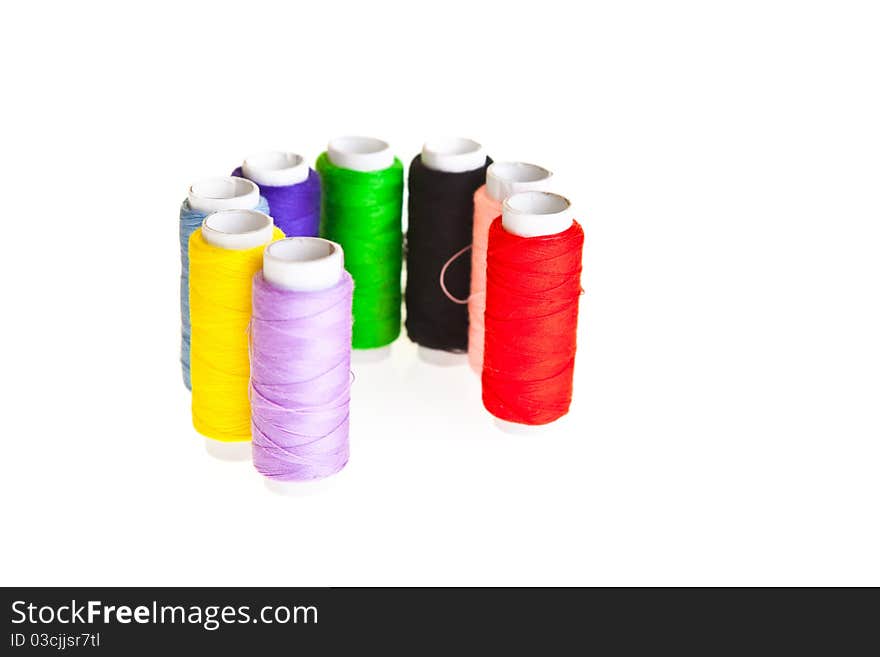 Colorful sewing threads isolated on white