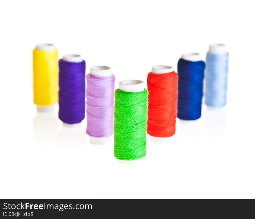 Colorful sewing threads isolated on white