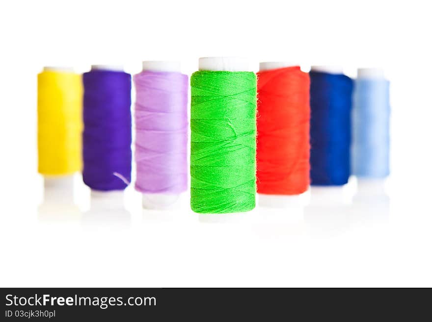 Colorful sewing threads isolated on white