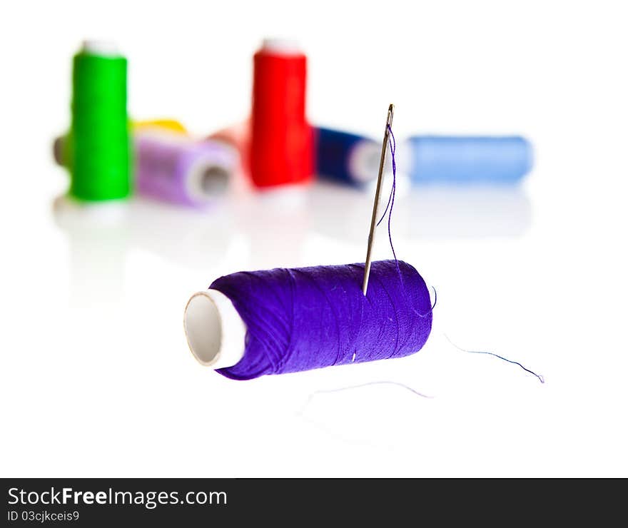 Colorful sewing threads isolated on white