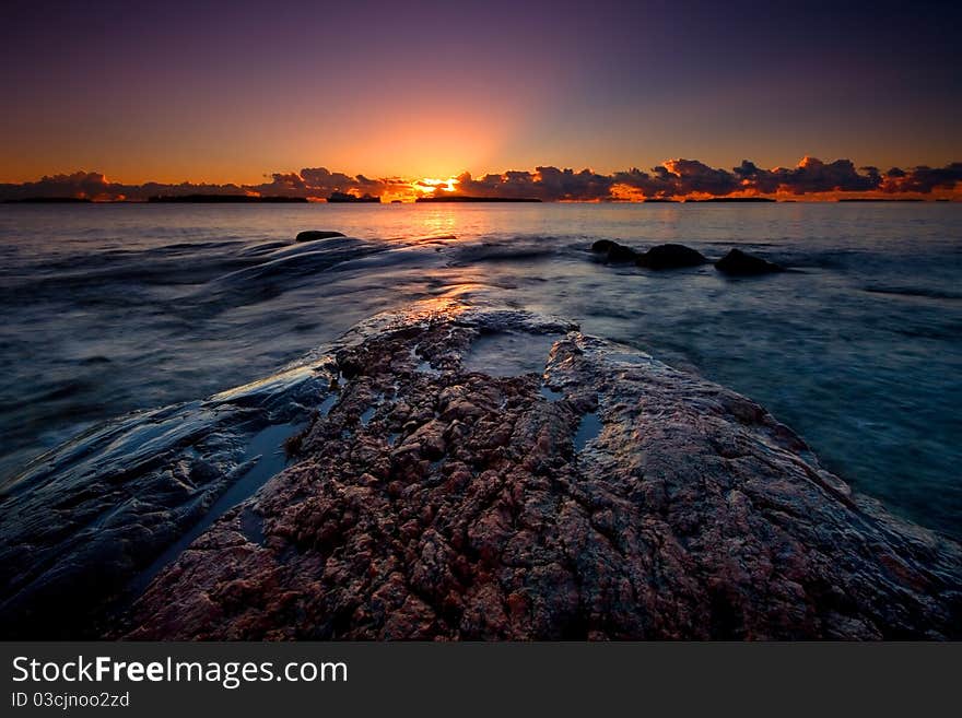 Sun is rising behind the dark clouds in the summer morning. Sun is rising behind the dark clouds in the summer morning.