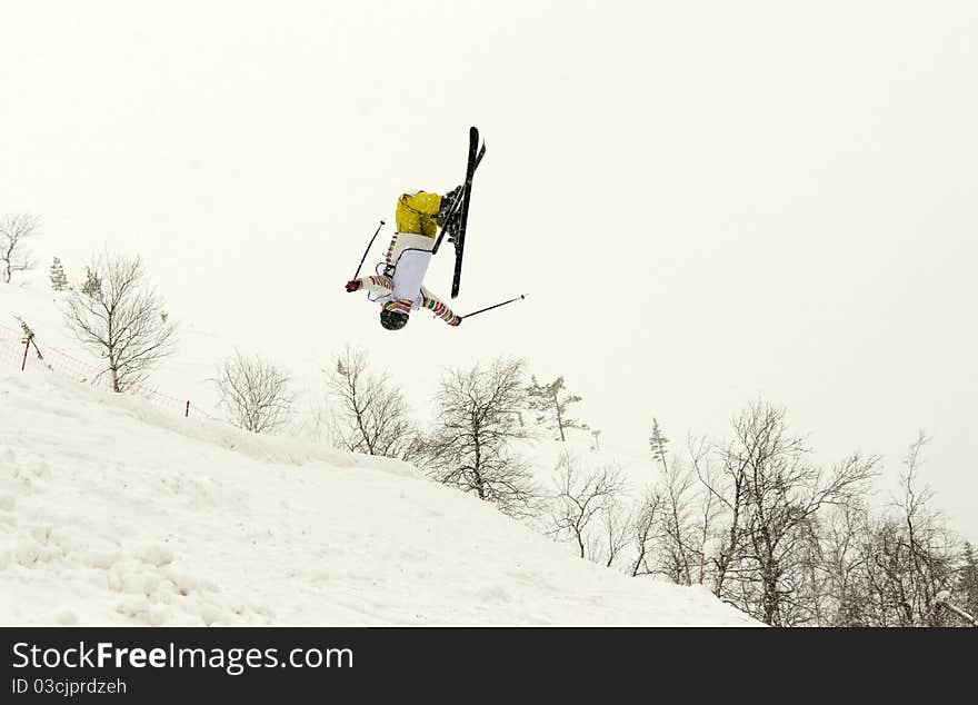 Skier in yellow trousers, flip in the air. Skier in yellow trousers, flip in the air