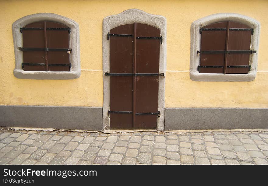 An old fairy styled house with locked wooden door and windows. An old fairy styled house with locked wooden door and windows