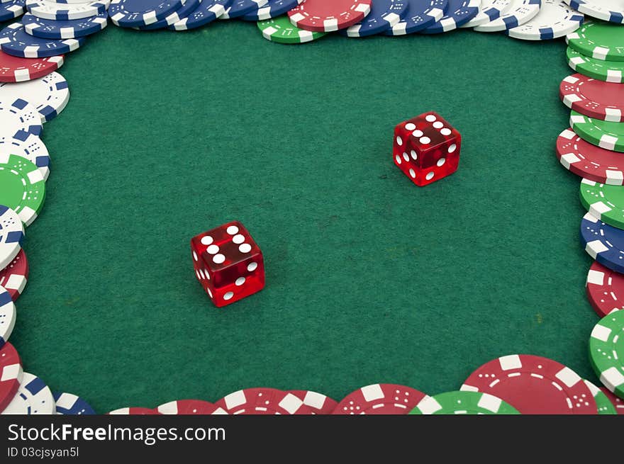 Dice and chips on a green table