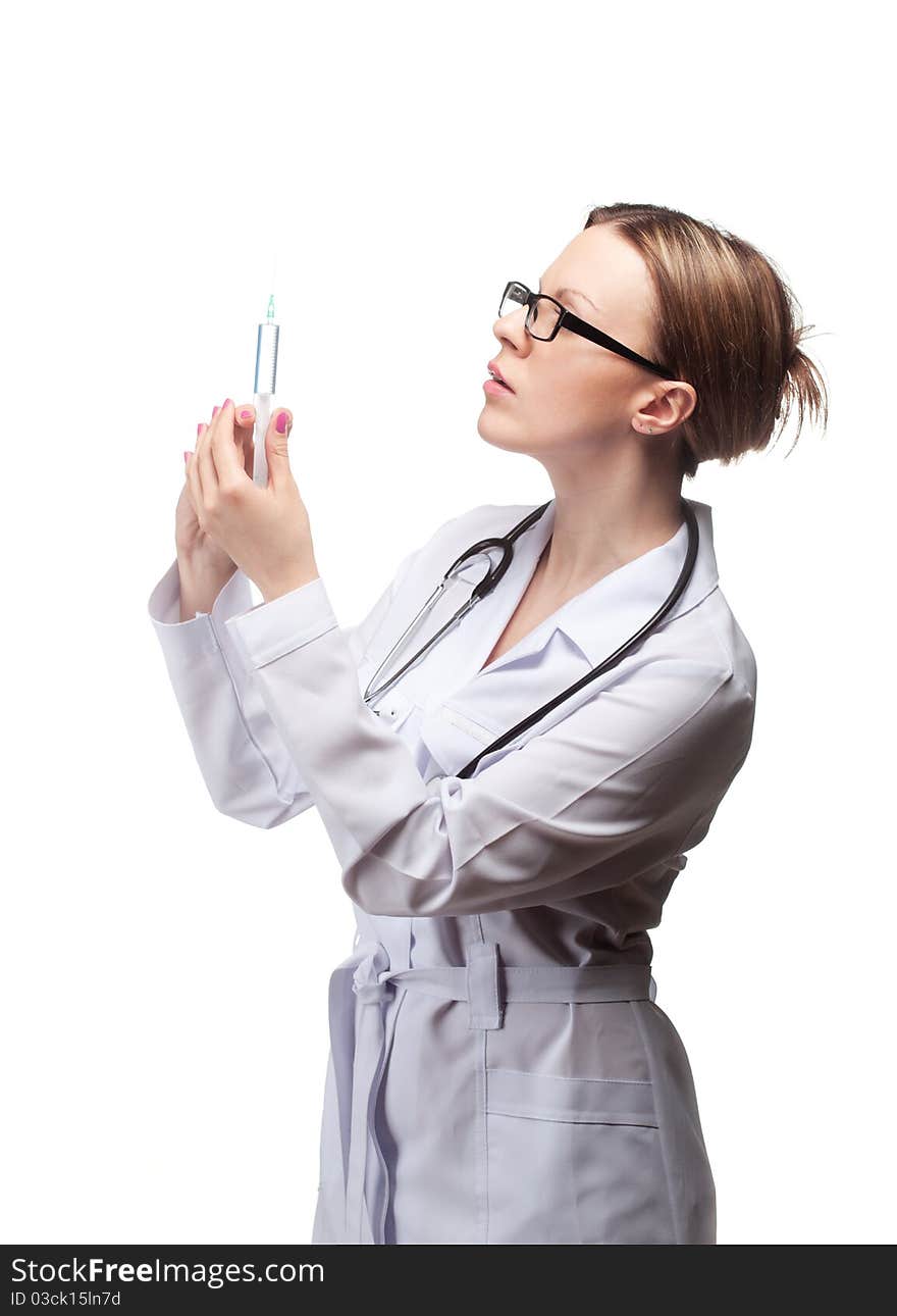 A young woman doctor with a syringe in the studio on a white background