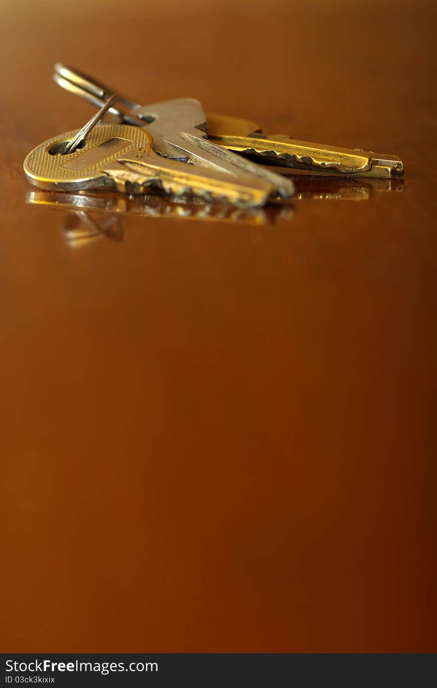 Bunch of keys , open the door, lying on the table, close up, blurred background. Bunch of keys , open the door, lying on the table, close up, blurred background