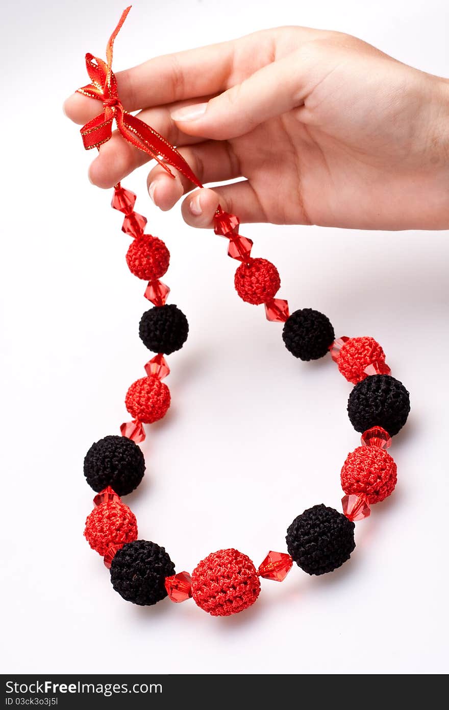 Necklace of beads knitted on a white background