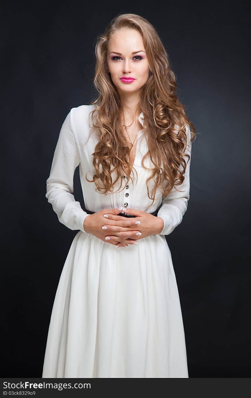 Smiling girl in white dress, studio isolated shot