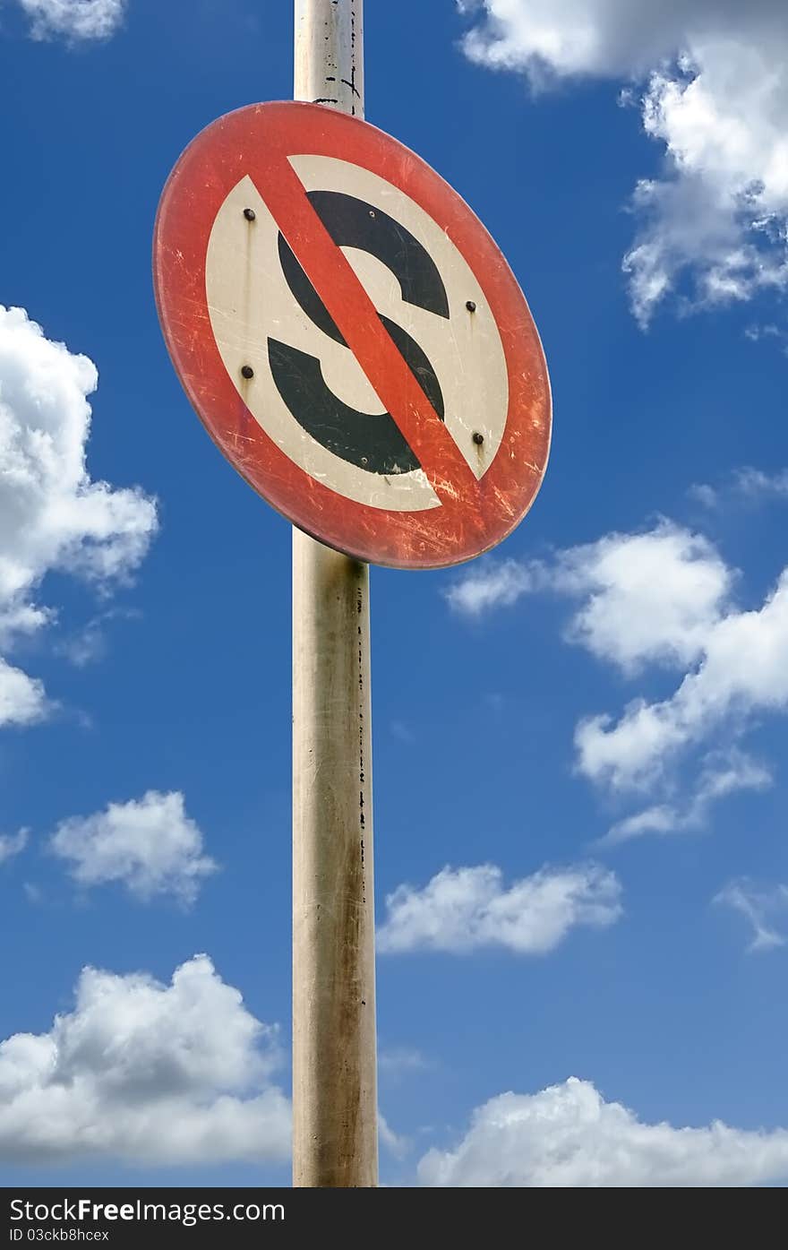 Round no stop sign on cloud blue sky