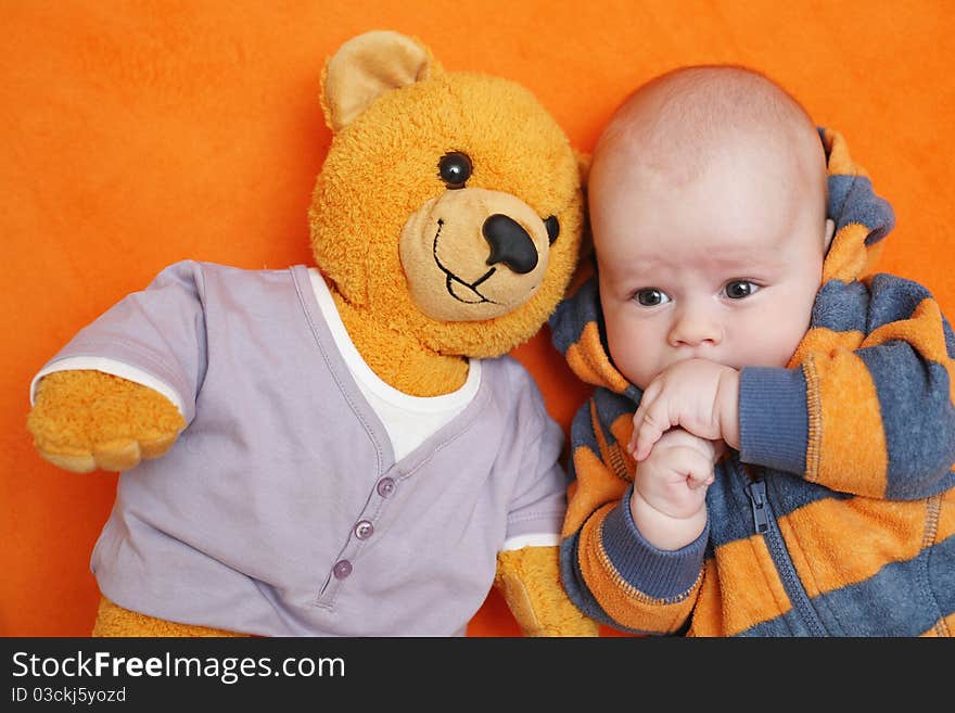 The baby lying on a back and its teddy bear. The baby lying on a back and its teddy bear