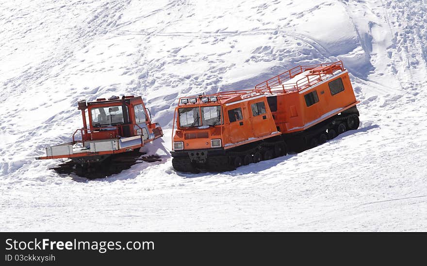 Winter special transportation orange vehicles for supplying purposes. Winter special transportation orange vehicles for supplying purposes