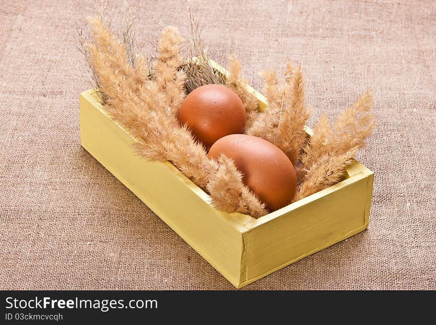 Chicken eggs in a wooden box