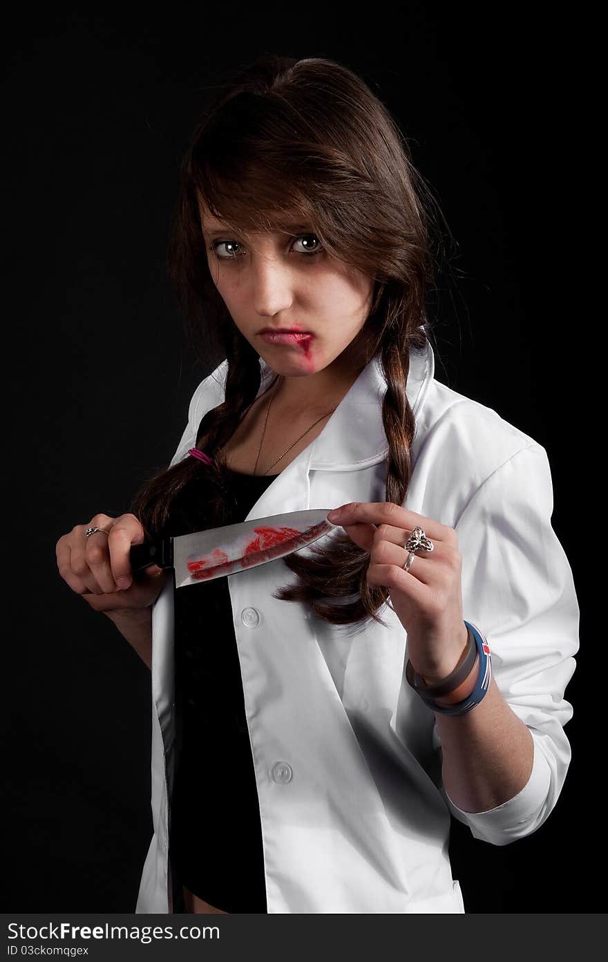 Crazy nurse holds a bloody knife