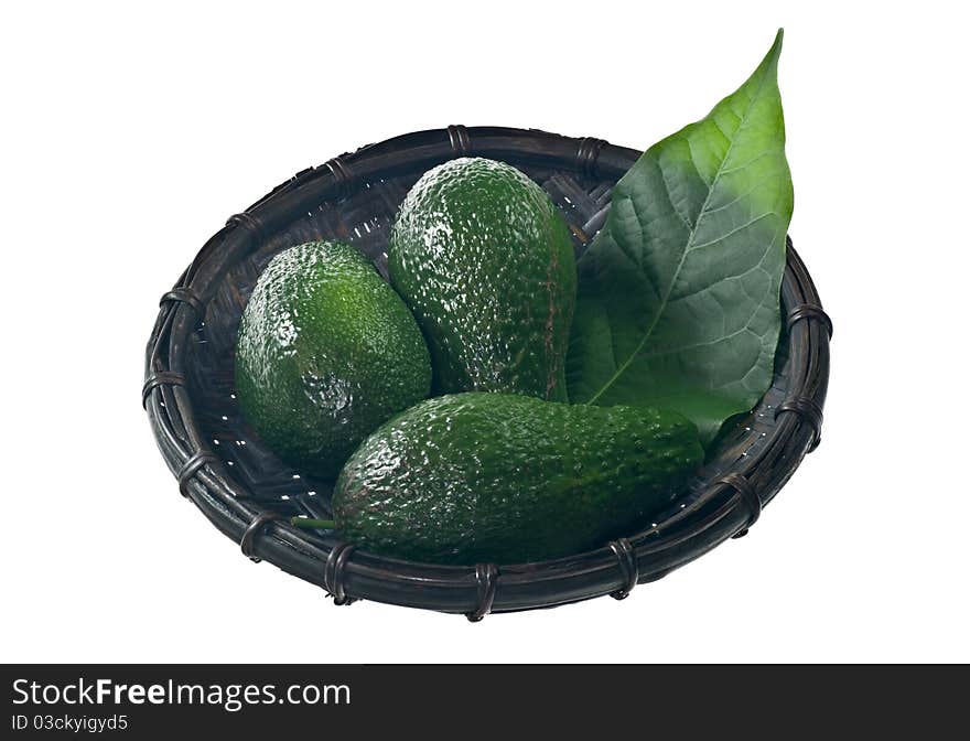 Avocado in a basket isolated on white