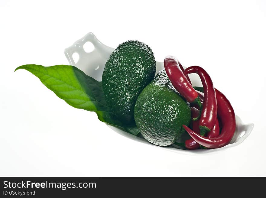 Avocado and red peppers on porcelain dish