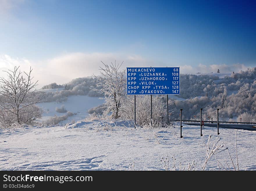 Road trips, travel, and sign: road sign and mountain landscape. Road trips, travel, and sign: road sign and mountain landscape