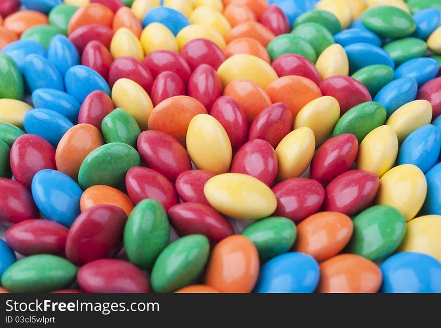 Many colored candy on a white background