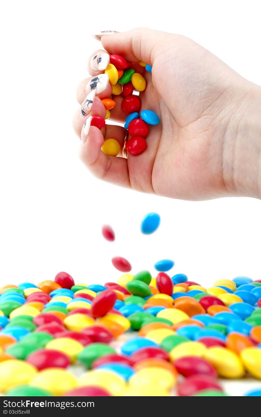 Girl throws candy on a white background