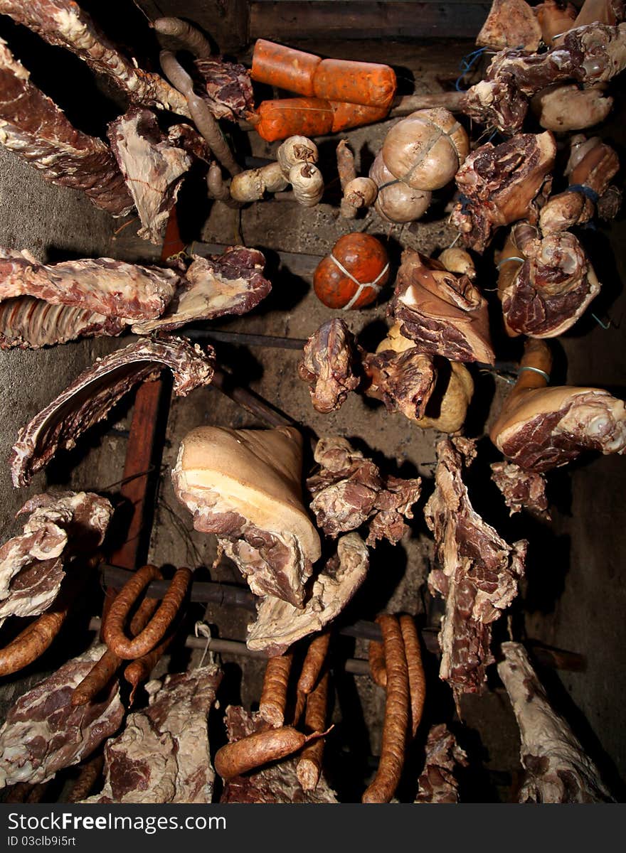 Variety of meats hanged from a sealing. Variety of meats hanged from a sealing