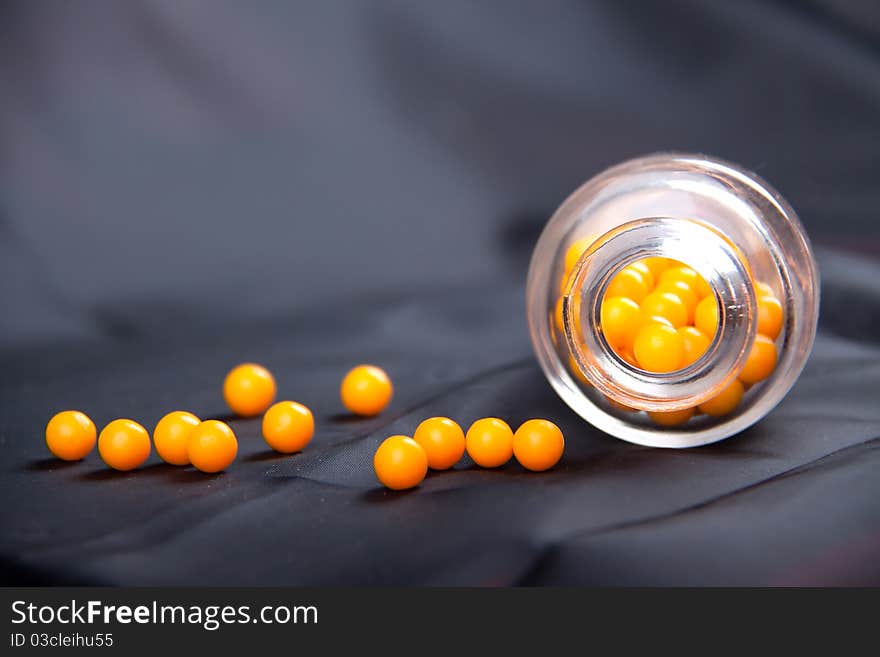 Round yellow vitamins and bank on a blue background