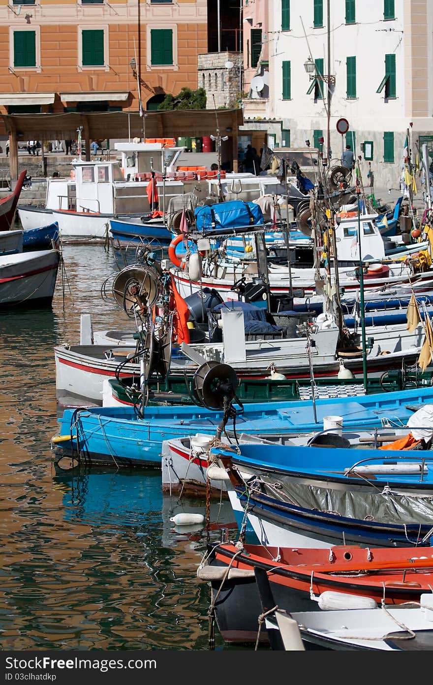 This photo shows a typical Italian port with several fishing boats and colorful in classic Italian province of Genoa, more precisely Camogli. This photo shows a typical Italian port with several fishing boats and colorful in classic Italian province of Genoa, more precisely Camogli