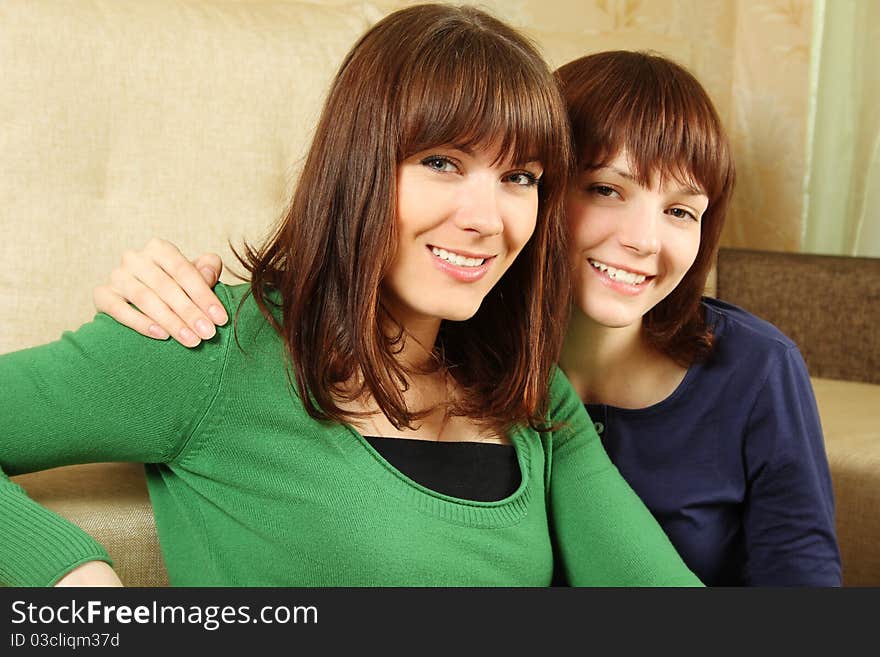 Two friends laughing together in the room, hugging both Caucasian. Two friends laughing together in the room, hugging both Caucasian.